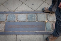 Kyle standing on either side of the Berlin Wall at the Berlin Wall Memorial