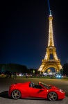 Ferrari and Eiffel Tower at night from Champ du Mars park in Paris