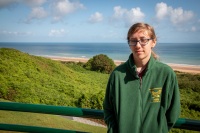 Kyle with Omaha Beach at the Normandy American Cemetery