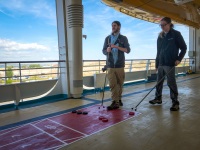 Paul and Kyle playning shuffleboard on Voyager of the Seas in Copenhagen
