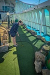 Suzanne playing mini-golf on Voyager of the Seas in the Baltic Sea