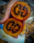 Tasting fruit at Paloquemao market in Bogota