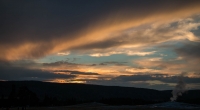 Old Faithful Geyser at sunset in Yellowstone