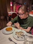 Kyle eating Creme Brulee at dinner in Silk Main Dining Room on Anthem of the Seas
