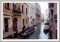 Venice: A Venetian gondolier along a small canal