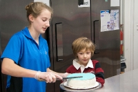 Helping frost a cake