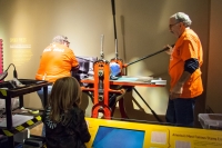 Kyle watching stamp printing demo at the Postal Museum