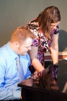 Ryan and Andrea sharing a piano