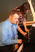 Ryan and Andrea sharing a piano