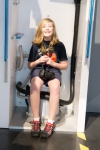 Kyle on Space Shuttle toilet at Kennedy Space Center